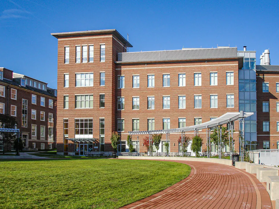 Denison University campus lawn with curved brick walk, concrete bands, brick buildings, and courtyard edge